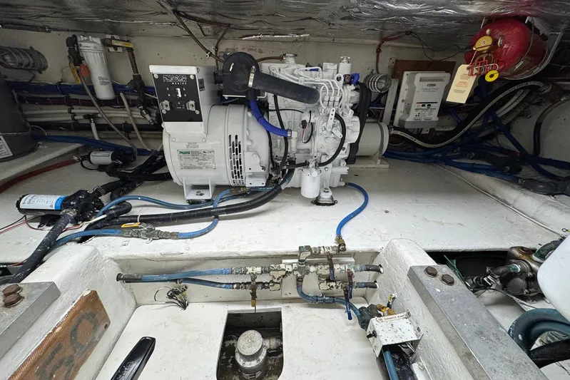 High Tide Yacht Photos Pics Engine room of a 1988 Buddy Davis 47 Convertible boat, showcasing mechanical components.