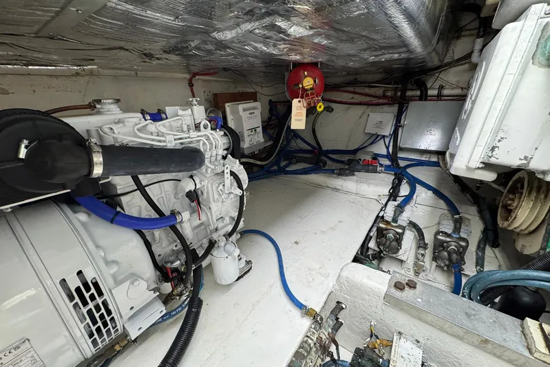 High Tide Yacht Photos Pics Engine room of a 1988 Buddy Davis 47 Convertible boat, showcasing mechanical components.