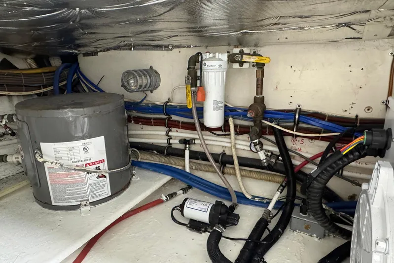 High Tide Yacht Photos Pics Engine room of a 1988 Buddy Davis 47 Convertible with wiring and plumbing components.