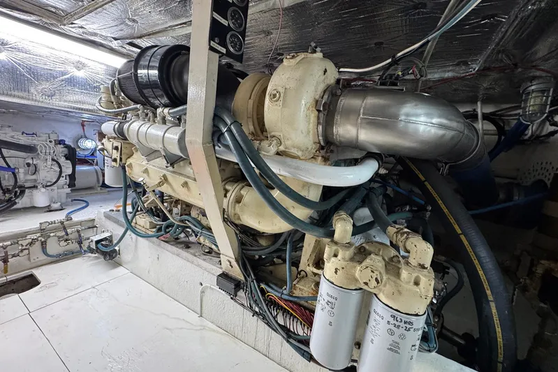 High Tide Yacht Photos Pics Engine room of a 1988 Buddy Davis 47 Convertible yacht, showcasing detailed machinery.