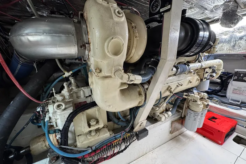 High Tide Yacht Photos Pics Engine room of a 1988 Buddy Davis 47 Convertible yacht, showcasing detailed machinery.