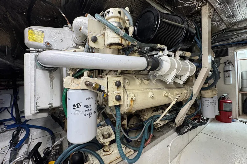 High Tide Yacht Photos Pics Engine room of a 1988 Buddy Davis 47 Convertible boat, showcasing detailed machinery and components.