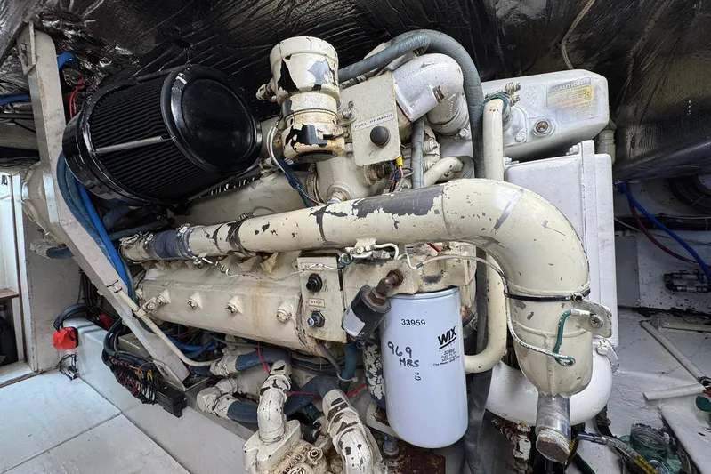 High Tide Yacht Photos Pics Engine room of a 1988 Buddy Davis 47 Convertible boat, showcasing detailed machinery.