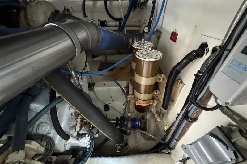 High Tide Yacht Photos Pics Engine room of 1988 Buddy Davis 47 Convertible with visible pipes and machinery.