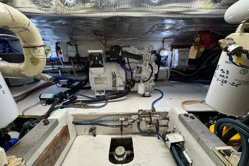 High Tide Yacht Photos Pics Engine room of 1988 Buddy Davis 47 Convertible with visible machinery and wiring.