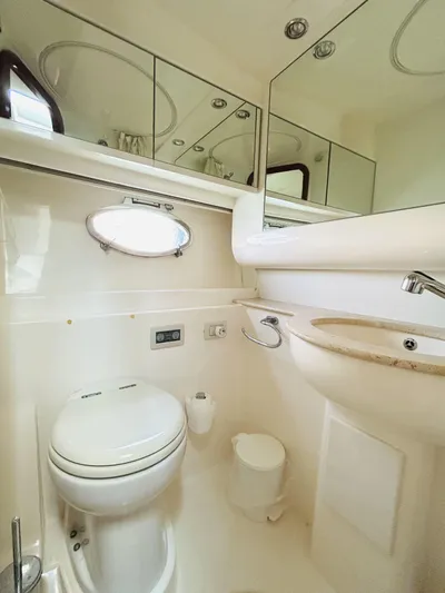  Yacht Photos Pics Bathroom interior of a 2006 Pershing 46 yacht, featuring a toilet, sink, and mirror.
