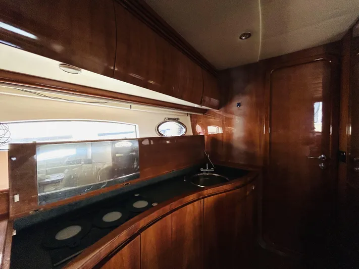  Yacht Photos Pics Luxurious wooden interior of 2006 Pershing 46 yacht kitchen area.