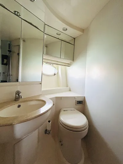  Yacht Photos Pics Luxurious bathroom in a 2006 Pershing 46 yacht, featuring modern fixtures and ample lighting.