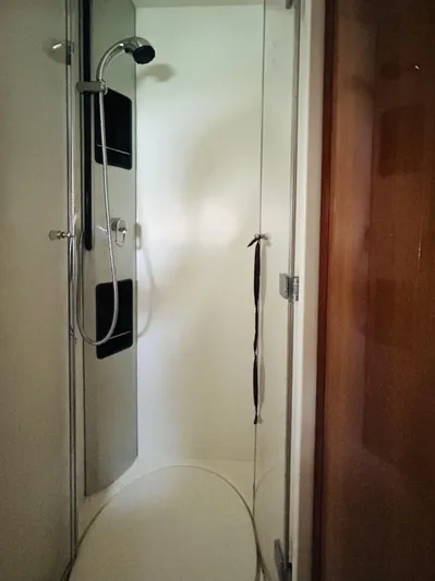  Yacht Photos Pics Shower area inside a 2006 Pershing 46 yacht, featuring modern fixtures and glass door.