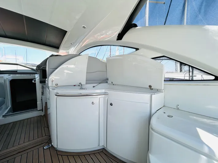  Yacht Photos Pics 2006 Pershing 46 yacht interior with sleek white cabinetry and wooden flooring.