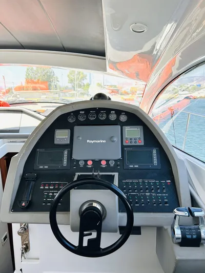  Yacht Photos Pics 2006 Pershing 46 yacht helm with Raymarine navigation system and control panel.