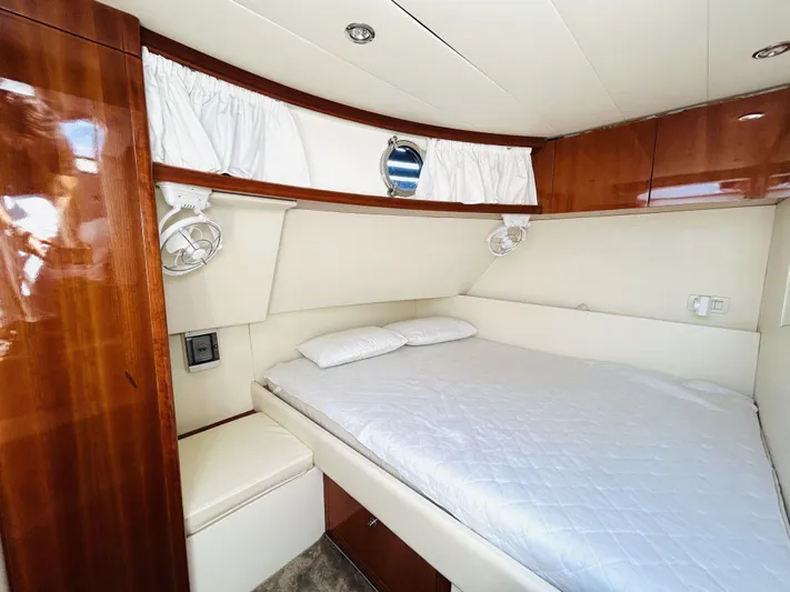  Yacht Photos Pics Luxurious cabin interior of a 2006 Pershing 46 yacht with elegant wood finishes.