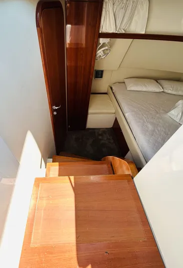  Yacht Photos Pics Interior cabin of 2006 Pershing 46 yacht with wooden stairs and bed.
