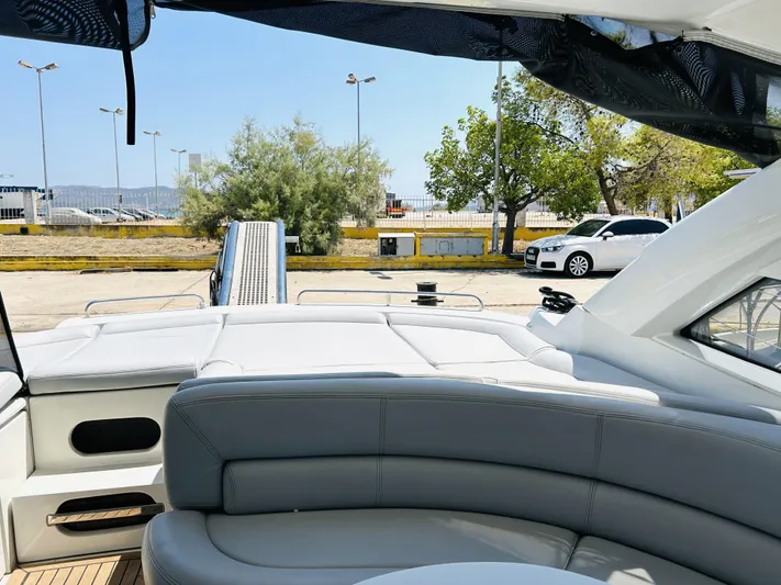  Yacht Photos Pics Luxury seating on a 2006 Pershing 46 yacht, docked with a scenic view.