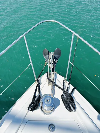  Yacht Photos Pics Bow of 2006 Pershing 46 yacht with anchor and ropes on turquoise water.