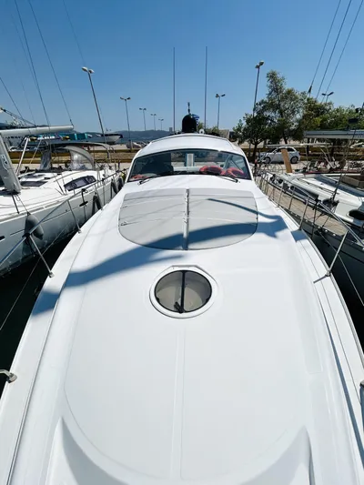  Yacht Photos Pics 2006 Pershing 46 yacht docked, showcasing sleek design and spacious deck.