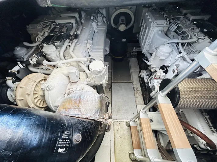  Yacht Photos Pics Engine room of a 2006 Pershing 46 yacht, showcasing dual engines and mechanical components.