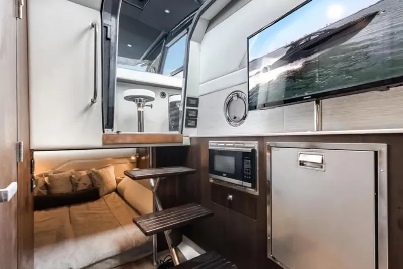  Yacht Photos Pics Luxurious 2023 Cruisers 42 yacht interior with bed, TV, microwave, and modern design.