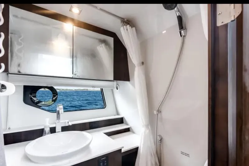  Yacht Photos Pics Luxurious 2023 Cruisers 42 yacht bathroom with modern fixtures and ocean view.