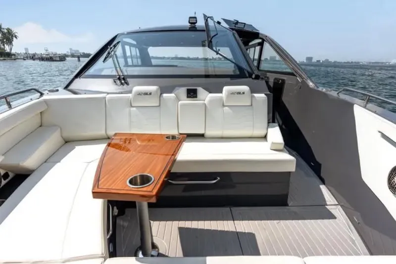  Yacht Photos Pics 2023 Cruisers 42 yacht with sleek seating and wooden table on open water.