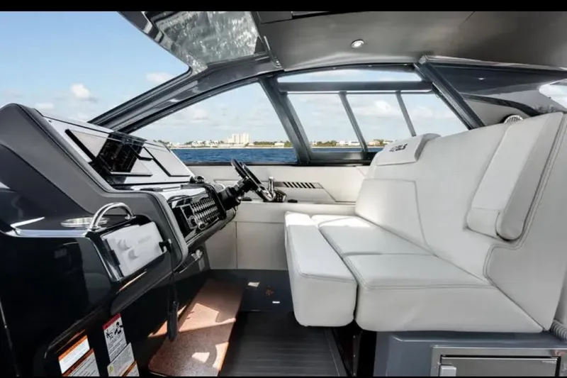  Yacht Photos Pics Interior of 2023 Cruisers 42 yacht with modern helm and white seating.