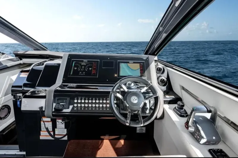  Yacht Photos Pics 2023 Cruisers 42 yacht helm with modern controls and ocean view.