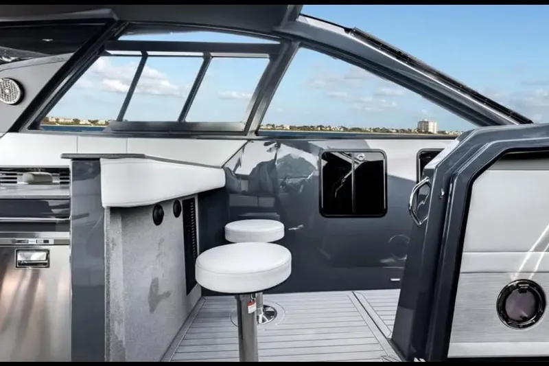  Yacht Photos Pics Modern interior of 2023 Cruisers 42 yacht with sleek design and bar stools.