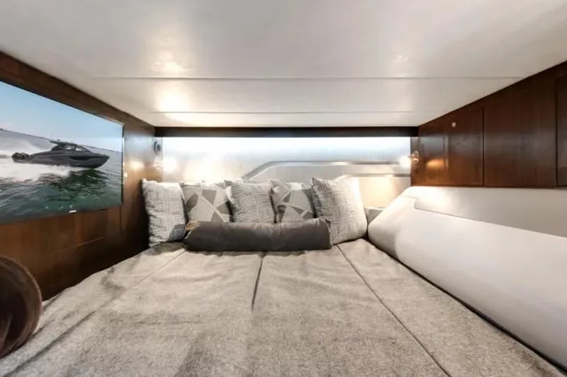  Yacht Photos Pics Luxurious cabin interior of 2023 Cruisers 42 yacht with cozy bedding and modern decor.