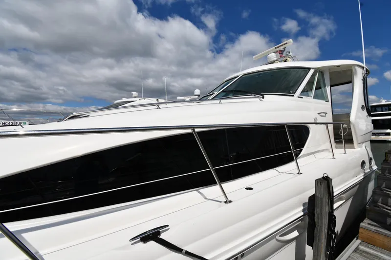 Seriously Yacht Photos Pics 2005 Sea Ray 390 Motor Yacht docked under a cloudy sky.