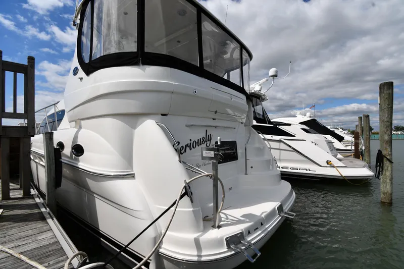 Seriously Yacht Photos Pics 2005 Sea Ray 390 Motor Yacht docked at marina, clear sky, adjacent to another boat.