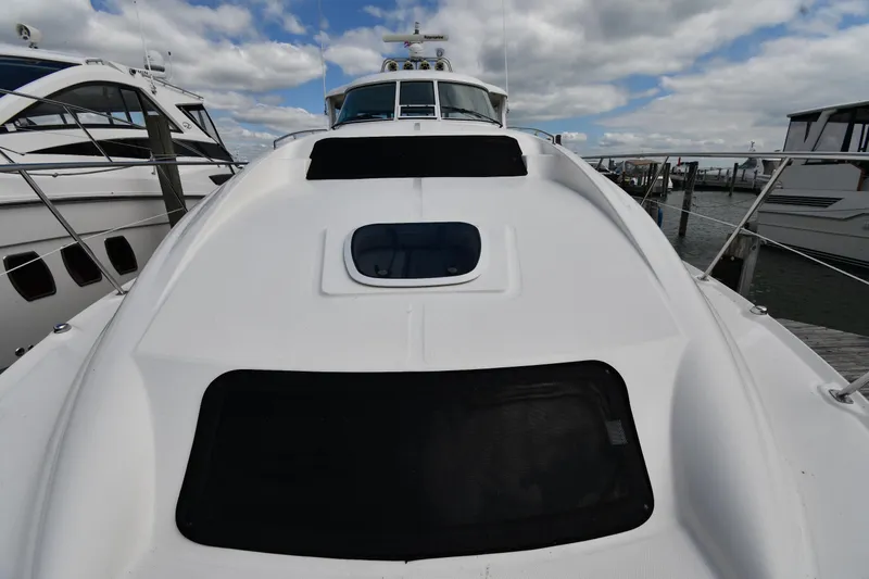 Seriously Yacht Photos Pics 2005 Sea Ray 390 Motor Yacht docked under cloudy sky.