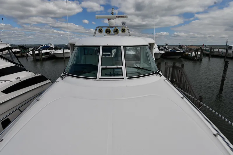 Seriously Yacht Photos Pics 2005 Sea Ray 390 Motor Yacht docked at marina under cloudy sky.