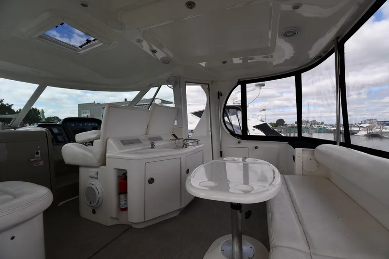 Seriously Yacht Photos Pics Interior of 2005 Sea Ray 390 Motor Yacht with seating and table, docked at marina.