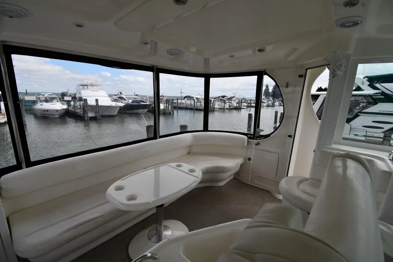 Seriously Yacht Photos Pics Interior of 2005 Sea Ray 390 Motor Yacht with marina view through large windows.