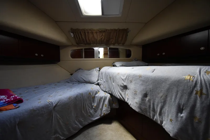 Seriously Yacht Photos Pics Cozy bedroom in 2005 Sea Ray 390 Motor Yacht with twin beds and star-patterned bedding.