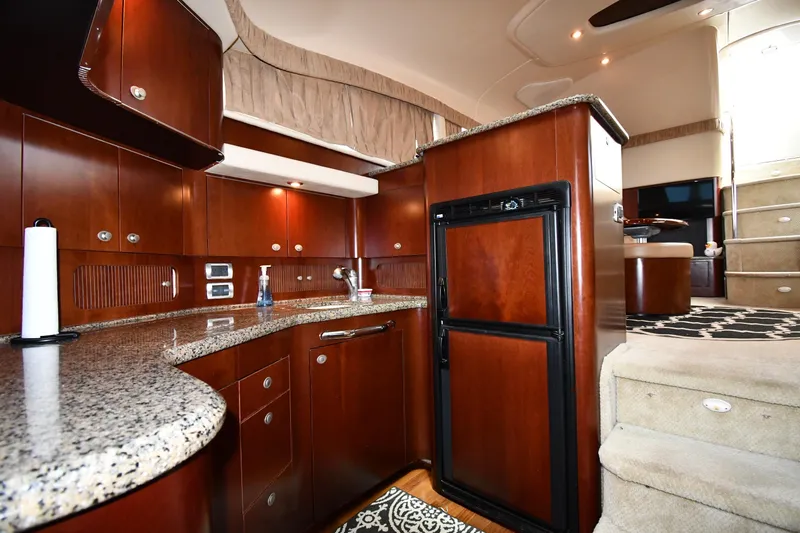 Seriously Yacht Photos Pics Luxurious interior of 2005 Sea Ray 390 Motor Yacht with elegant wood cabinetry and modern amenities.