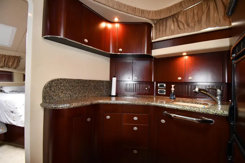 Seriously Yacht Photos Pics Luxurious 2005 Sea Ray 390 Motor Yacht kitchen with granite countertops and rich wood cabinetry.