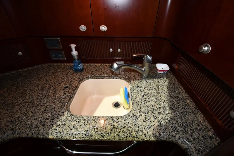 Seriously Yacht Photos Pics Luxurious 2005 Sea Ray 390 Motor Yacht kitchen sink with granite countertop.