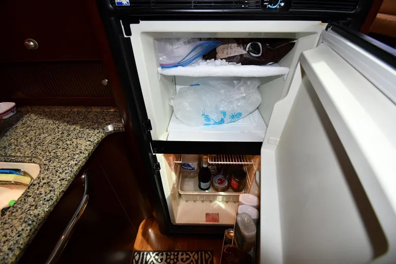 Seriously Yacht Photos Pics Open refrigerator in 2005 Sea Ray 390 Motor Yacht kitchen, showing ice and beverages.