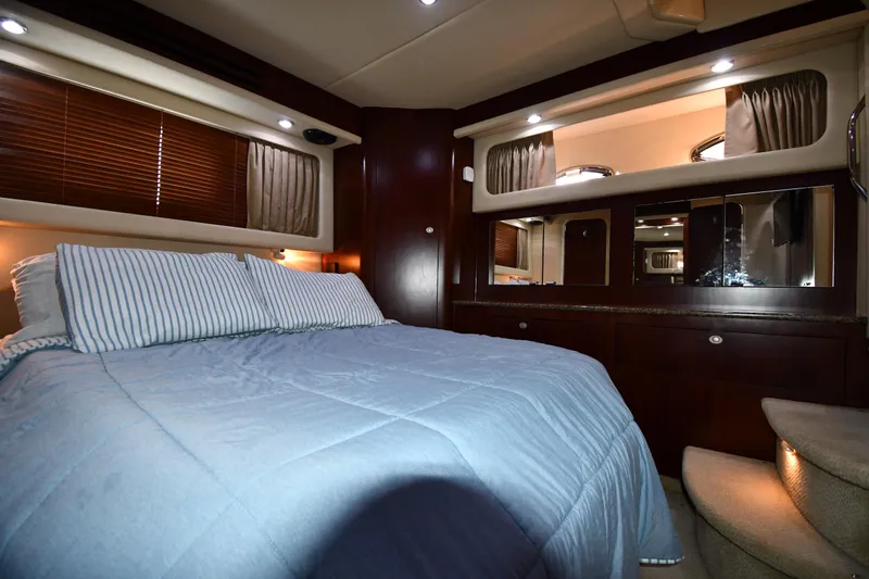 Seriously Yacht Photos Pics Luxurious bedroom interior of 2005 Sea Ray 390 Motor Yacht with elegant wood finishes.