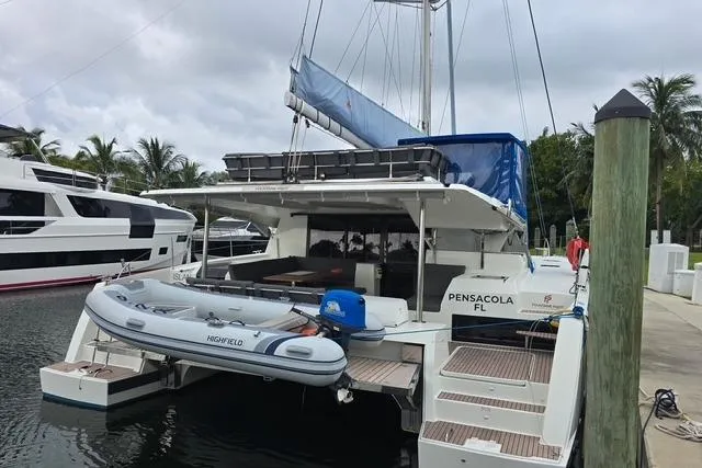 Island Nomad Yacht Photos Pics 2022 Fountaine Pajot Tanna 47 catamaran docked with inflatable boat, Pensacola, FL.