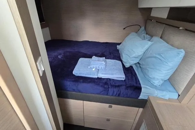 Island Nomad Yacht Photos Pics Cozy bedroom in 2022 Fountaine Pajot Tanna 47 yacht with blue bedding.