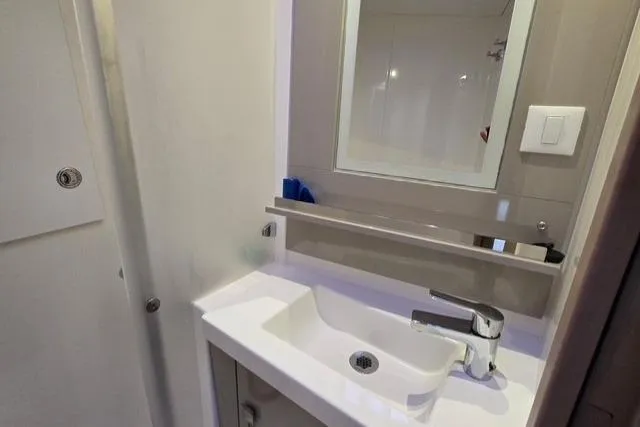 Island Nomad Yacht Photos Pics Bathroom sink area in 2022 Fountaine Pajot Tanna 47 yacht, featuring modern fixtures.
