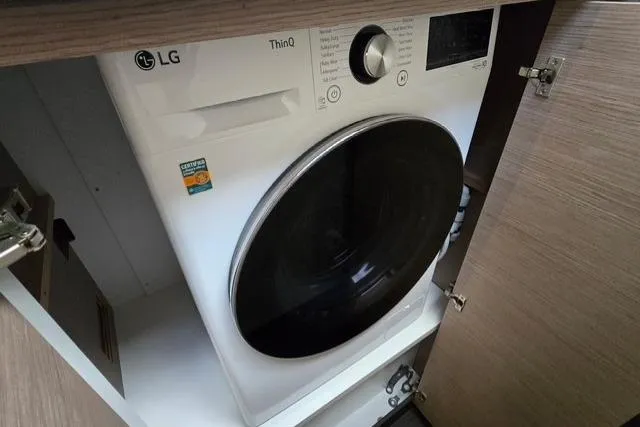 Island Nomad Yacht Photos Pics LG ThinQ washer inside 2022 Fountaine Pajot Tanna 47 yacht cabinet.