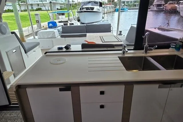 Island Nomad Yacht Photos Pics Modern kitchen on 2022 Fountaine Pajot Tanna 47 yacht, overlooking marina.
