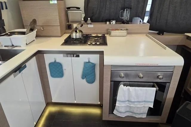 Island Nomad Yacht Photos Pics Modern kitchen in 2022 Fountaine Pajot Tanna 47 yacht with stove and oven.