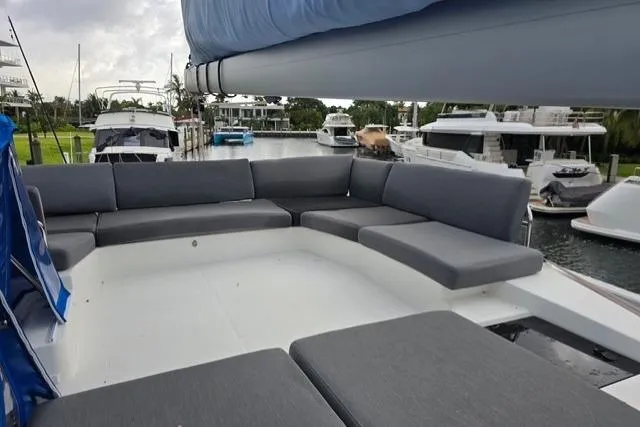 Island Nomad Yacht Photos Pics 2022 Fountaine Pajot Tanna 47 yacht with spacious outdoor seating area in marina.