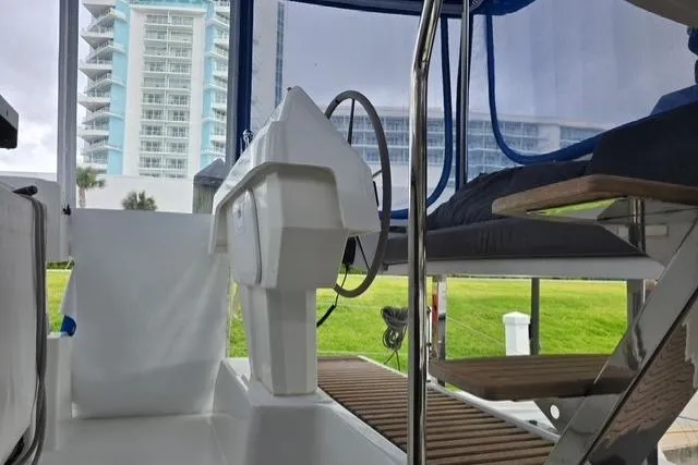 Island Nomad Yacht Photos Pics 2022 Fountaine Pajot Tanna 47 yacht helm with modern design and cityscape backdrop.