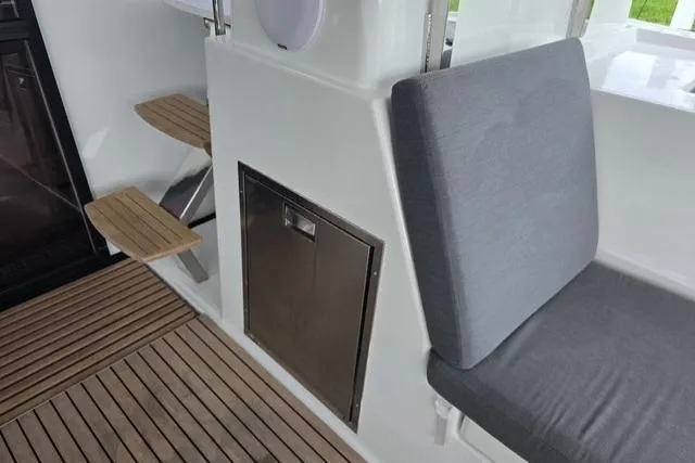 Island Nomad Yacht Photos Pics Fountaine Pajot Tanna 47 yacht interior, featuring wooden steps and cushioned seating, 2022 model.