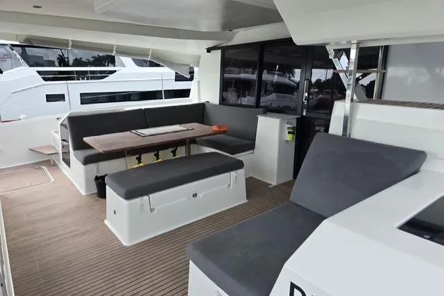Island Nomad Yacht Photos Pics 2022 Fountaine Pajot Tanna 47 yacht interior with modern seating and dining area.